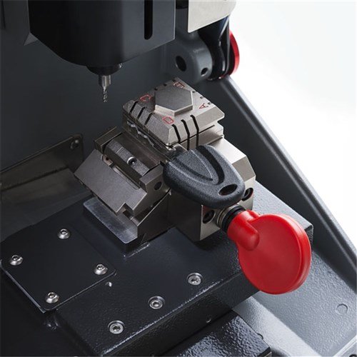 A key-cutting machine cutting the blade of a car key